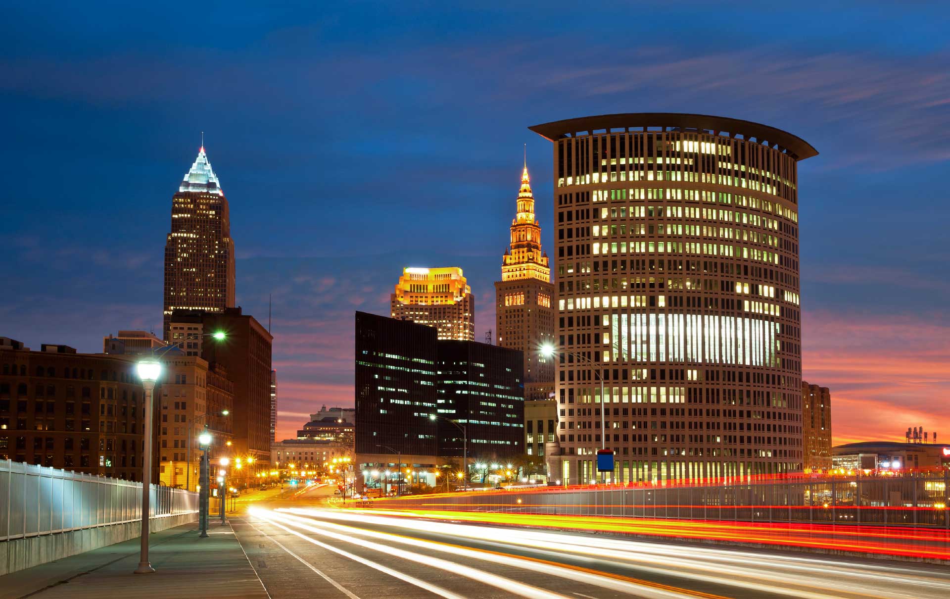 The city of Cleveland skyline at night, with the Terminal Tower and Key Building lit up.